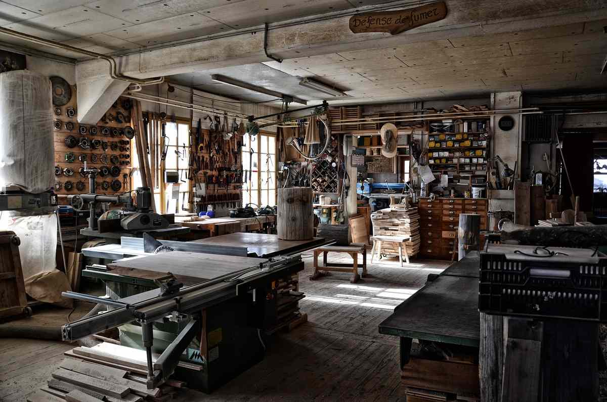 Un atelier de menuiserie avec scie à table, outils, bois Un atelier de menuiserie avec scie à table, outils, bois